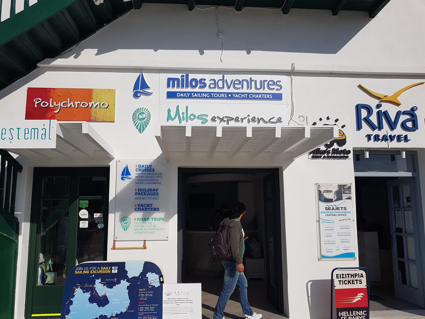 Ferry ticket offices for Seajets and Hellenic Seaways lining the harbour front in Adamas