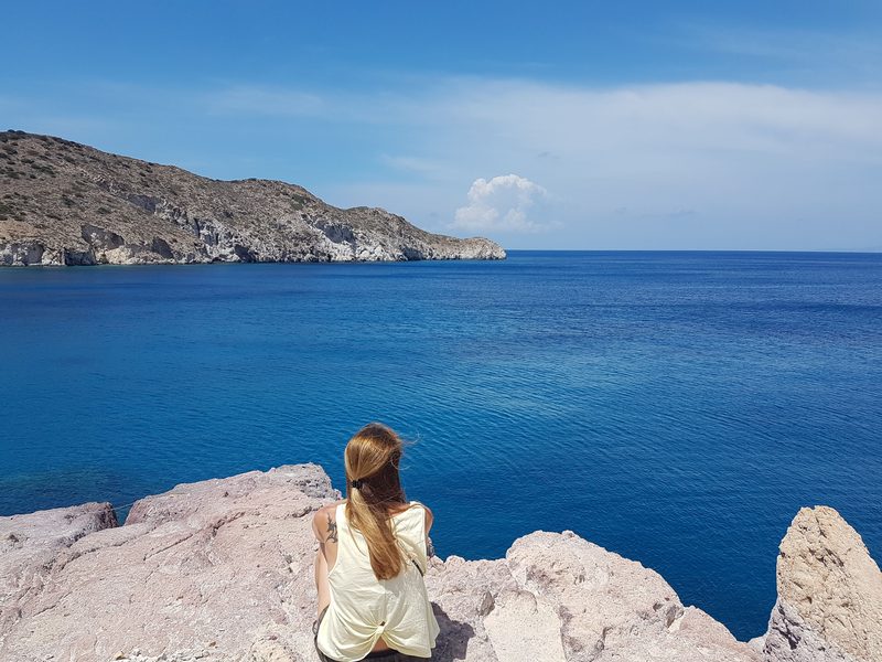 A sheltered sandy bay on the north coast of Milos, low headlands on each side