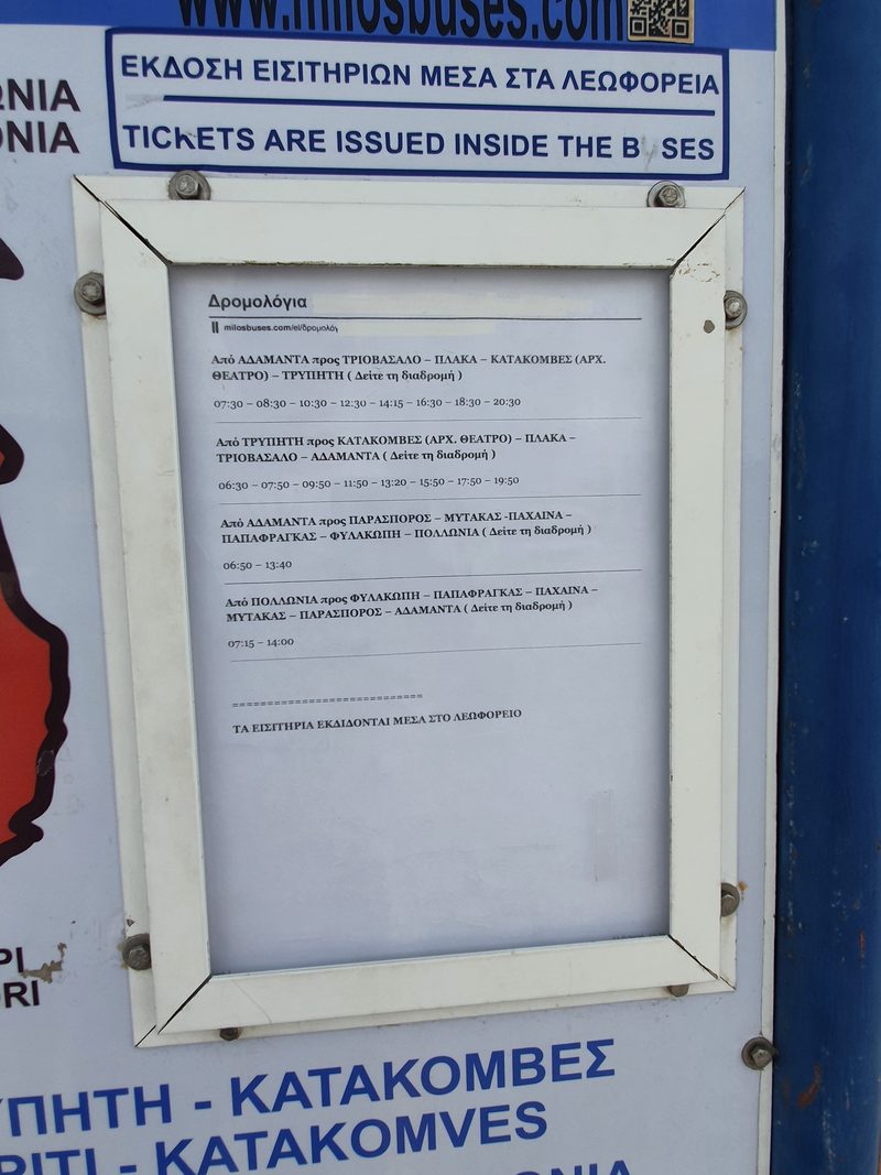 A close-up of the printed bus timetable posted at the Adamas bus terminal on Milos