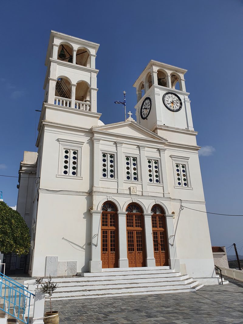 The white bell and clock tower of the Panagia Korfiatissa church, a landmark of Plaka's skyline