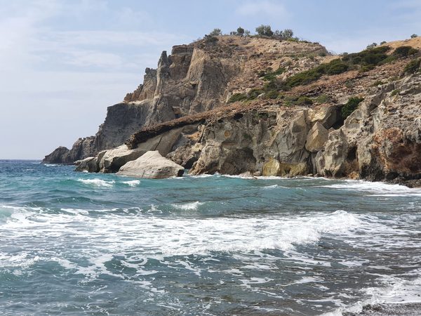 The sheer pale cliffs and sea caves of Kleftiko dropping straight into deep blue water