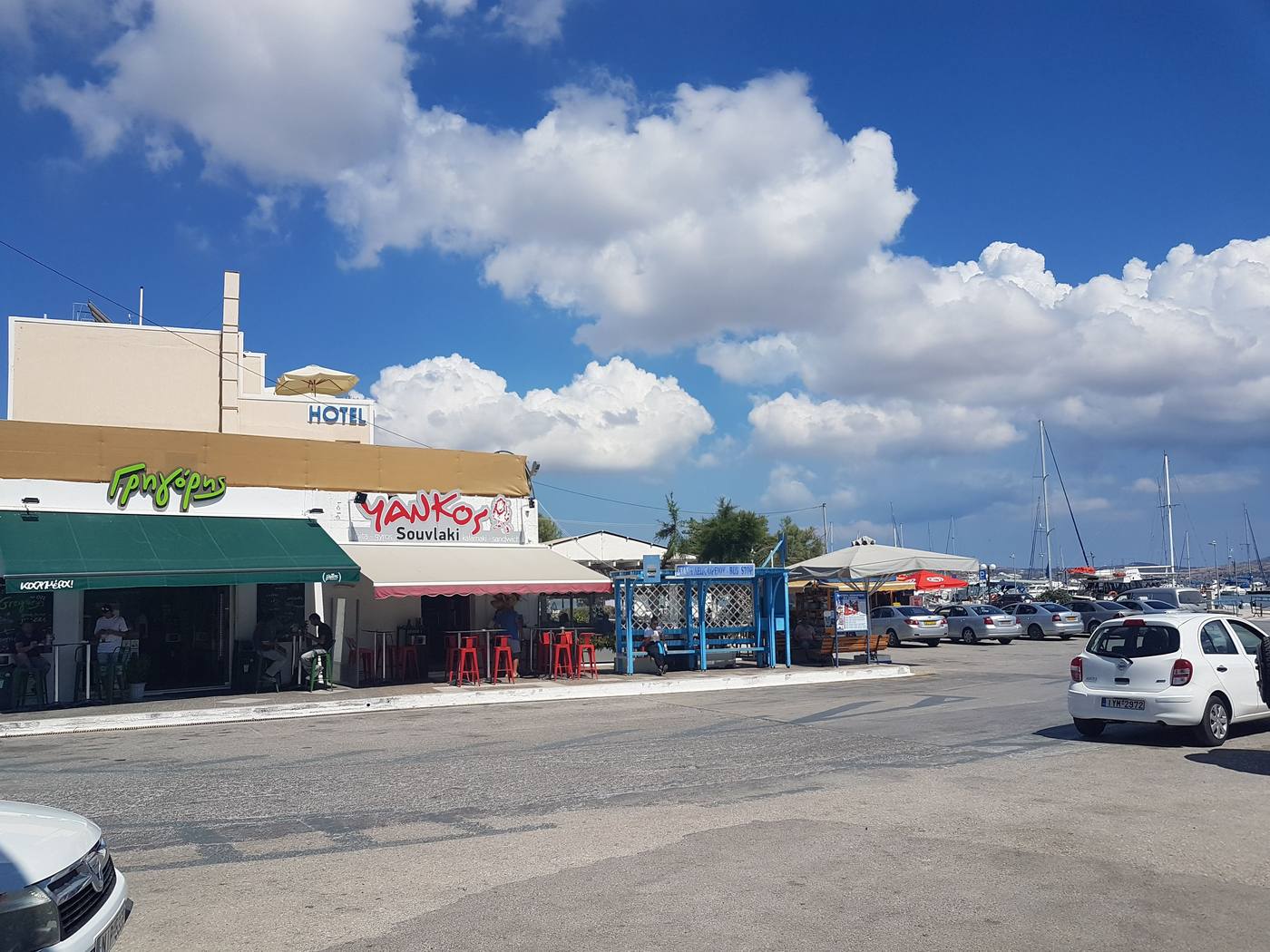 The bus stop shelter on the Adamas harbourfront in Milos, marked in Greek and English