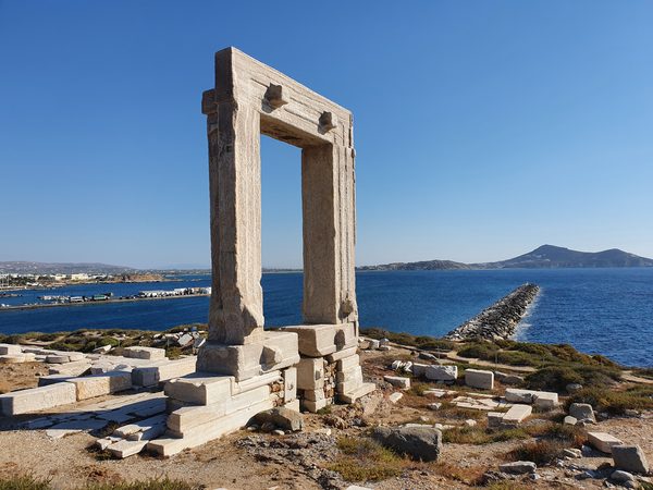 The Portara, a massive marble doorway standing alone on a rocky islet at the entrance to Naxos harbour