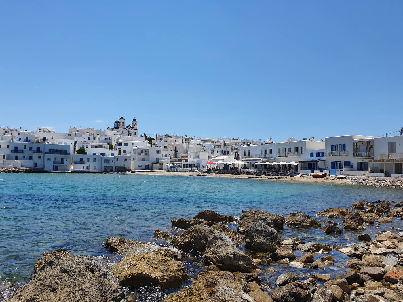 The whitewashed village of Naoussa on Paros seen across its small fishing harbour