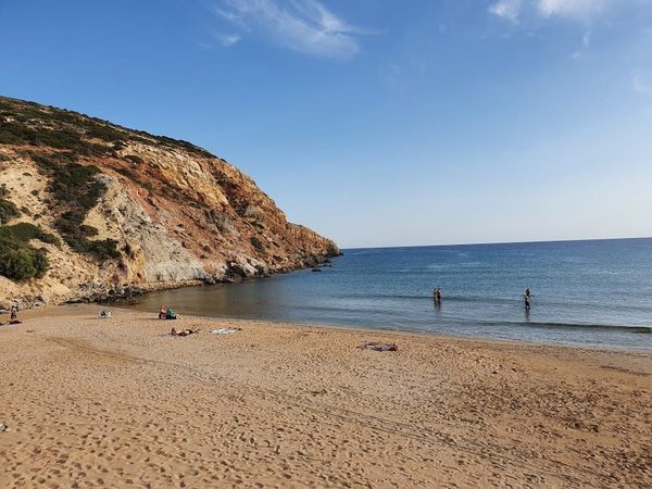 Provatas beach in Milos, with golden sand backed by red-brown cliffs