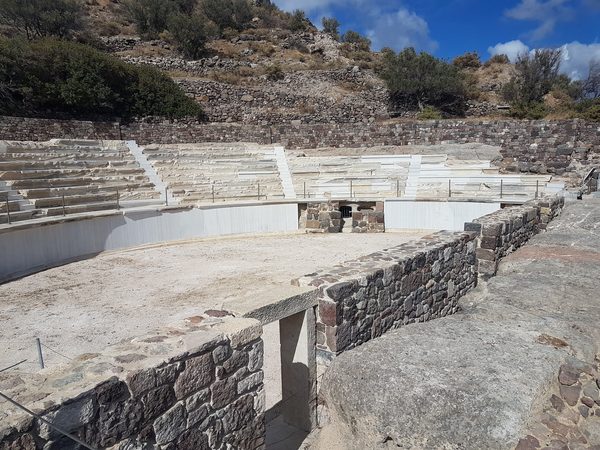 Curved rows of white marble seating at the ancient theatre near Trypiti, Milos